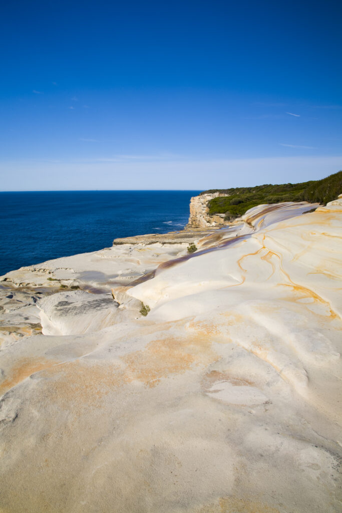 Australia, New South Wales, Royal National Park. Sandstone cliifs overlooking the Pacific Ocean viewed from the Royal National Park Coastal Track.