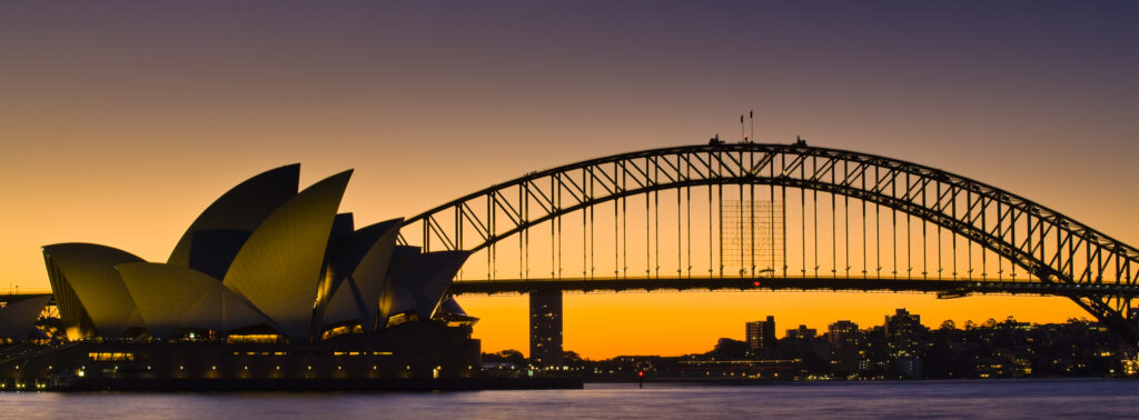 Australia, New South Wales, Sydney. Sydney Harbour bridge and the opera house viewed at sunset.