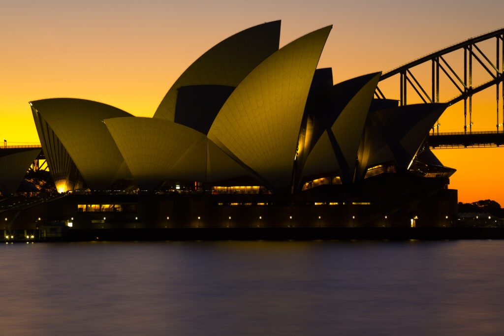 Australia, New South Wales, Sydney. Sydney Harbour bridge and the opera house viewed at sunset.
