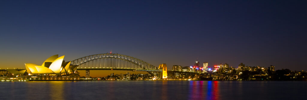 Australia, New South Wales, Sydney. Sydney Harbour bridge and the opera house viewed at dusk.