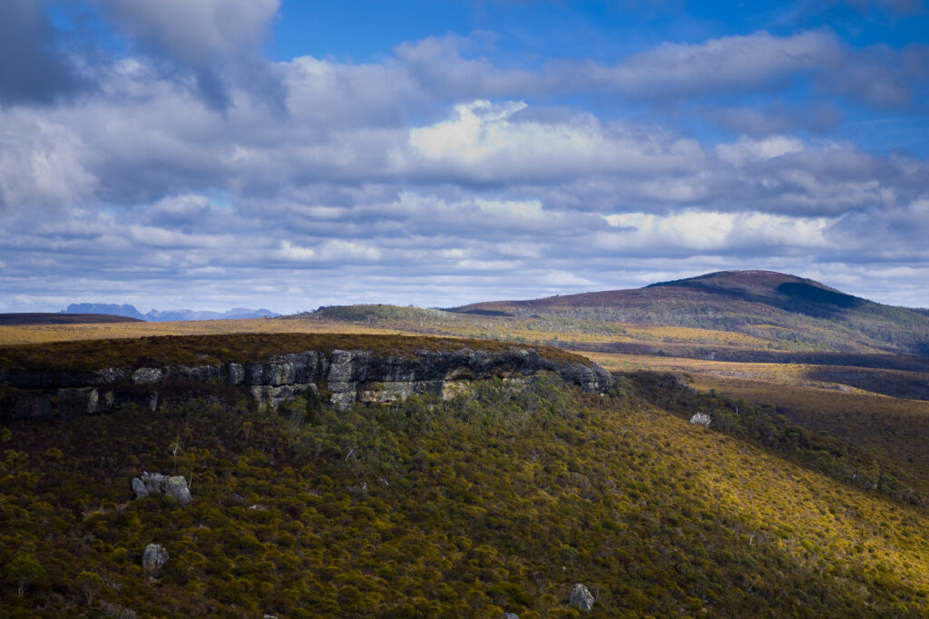 Australia, Tasmania, Cradle Mt - Lake St Clair National Park. Passing light highlights the crags and mountains of the National Park encountered whilst walking the Overland Track.