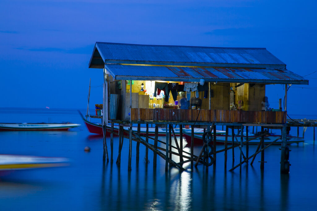 Sabah Malaysia, Borneo, Mabul Island. Water village on Mabul Island near Sipadan, viewed at dusk.