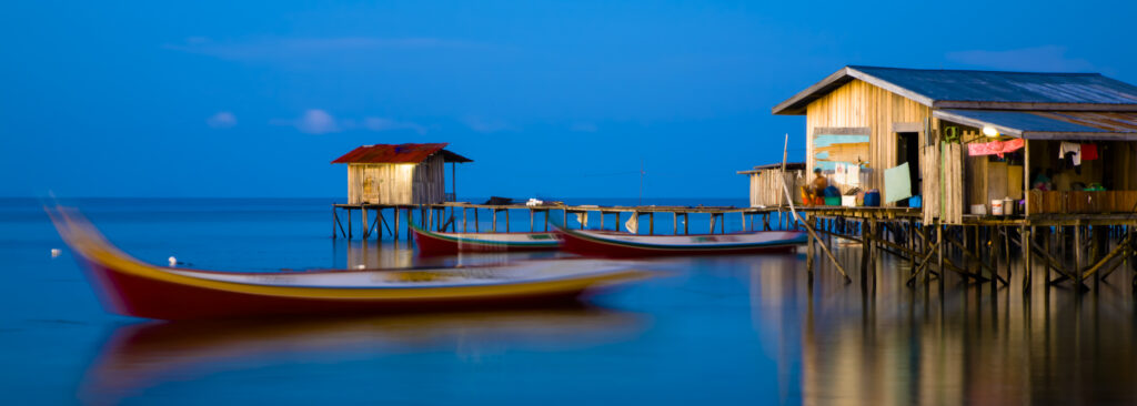 Sabah Malaysia, Borneo, Mabul Island. Water village on Mabul Island near Sipadan, viewed at dusk.
