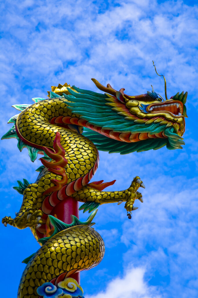 Thailand, Bangkok, Wat Chana Songkram. A statue of a Dragon reaches upwards from a building forming part of the Wat Chana Songkram complex.