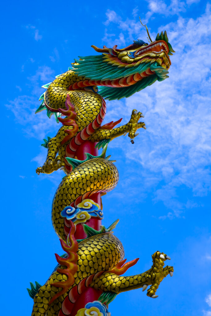 Thailand, Bangkok, Wat Chana Songkram. A statue of a Dragon reaches upwards from a building forming part of the Wat Chana Songkram complex.