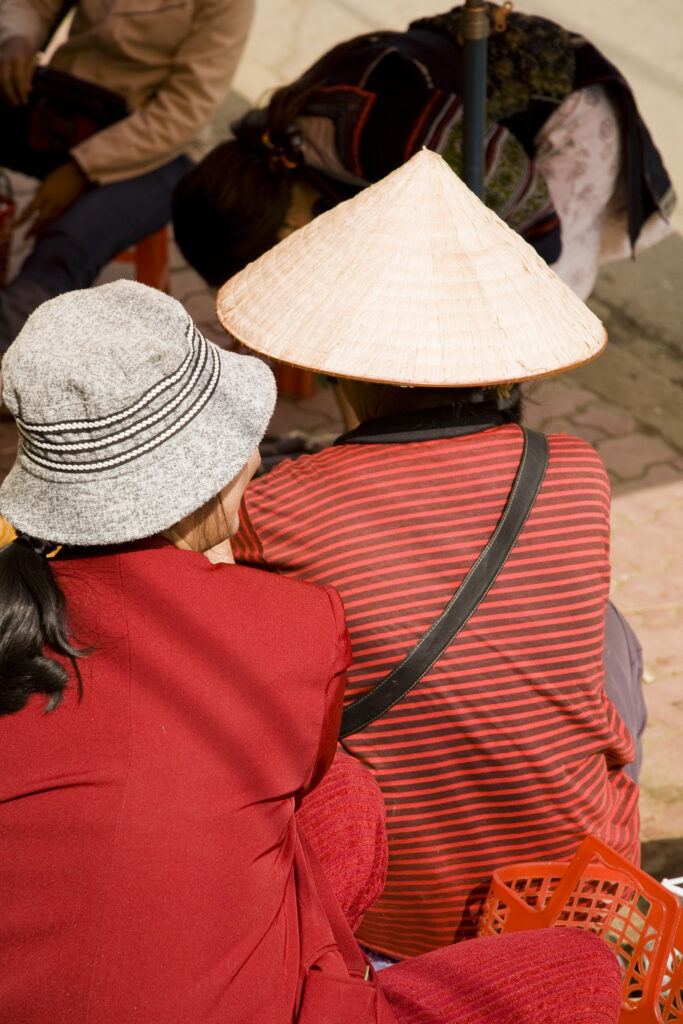 Vietnam, Northern Vietnam, Sapa. Vietnamese women selling local produce at a food market in Sapa.