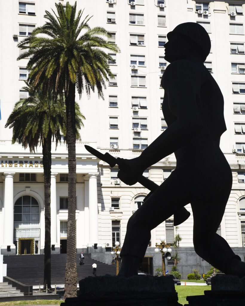 Argentina, Buenos Aires Province, Buenos Aires. Silhouted statue of a soldier outside a military building in Buenos Aires.