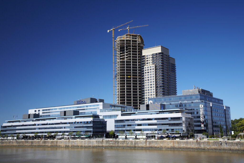Argentina, Buenos Aires Province, Buenos Aires. New development of buidings and construction site on the restored dock side of Puerto Madero.