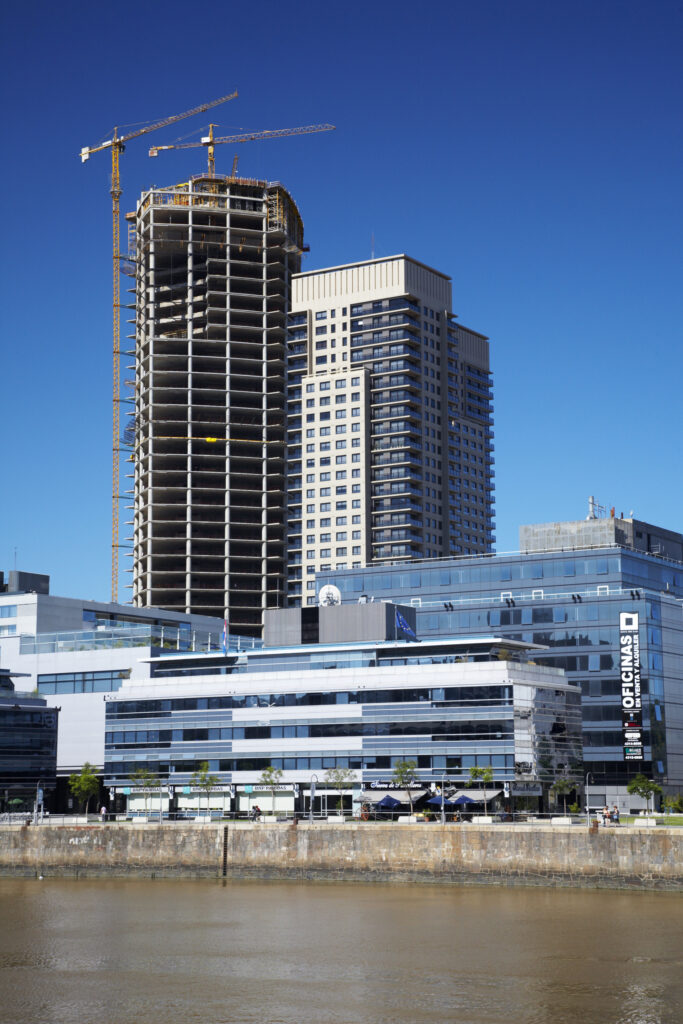 Argentina, Buenos Aires Province, Buenos Aires. New development of buidings and construction site on the restored dock side of Puerto Madero.