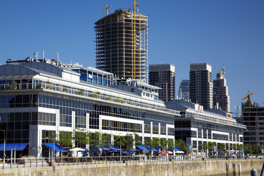 Argentina, Buenos Aires Province, Buenos Aires. New development of buidings and construction site on the restored dock side of Puerto Madero.
