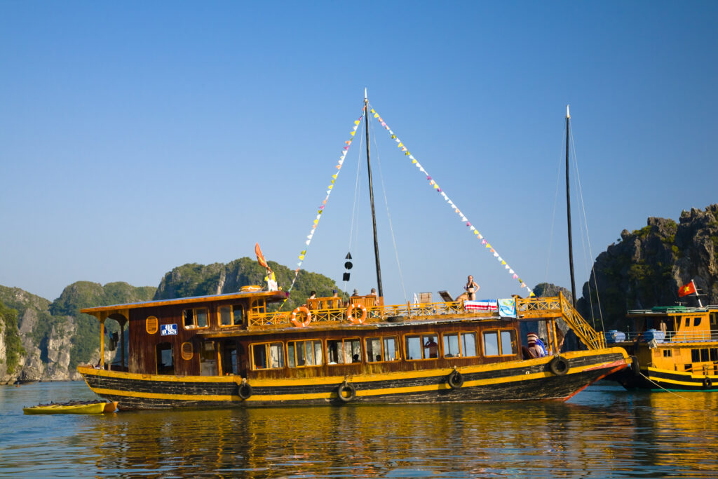 Vietnam, Northern Vietnam, Halong Bay. Tourist boat amid the islands of Halong Bay near Cat Ba Island.