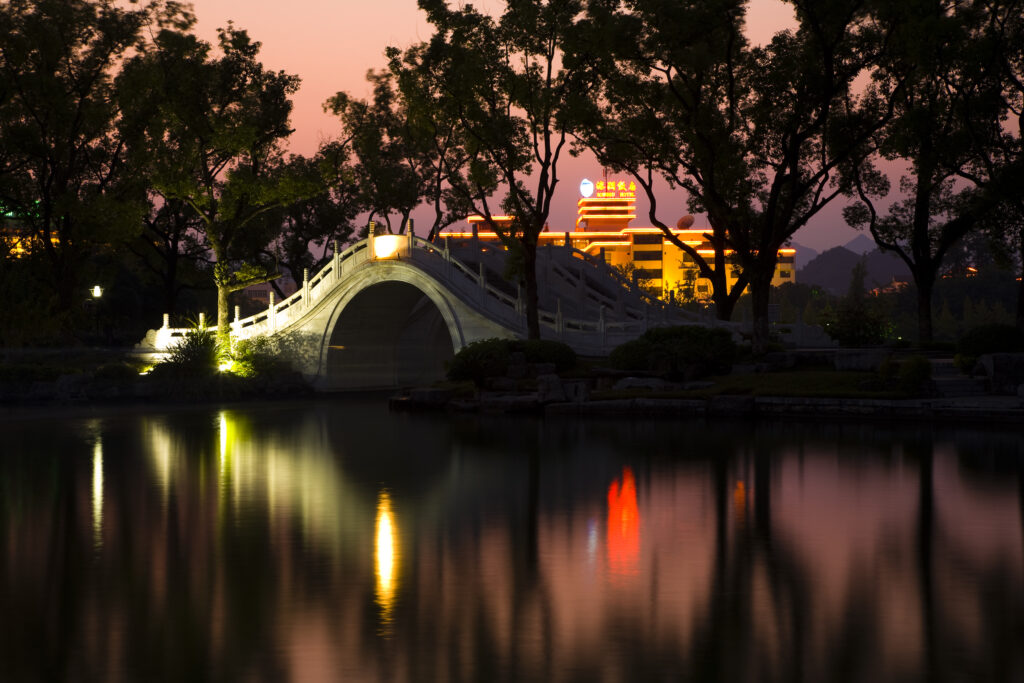 China, Guangxi Zhuang Autonomous Region, Guilin City. Illuminated bridge and waterside in downtown Guilin city.