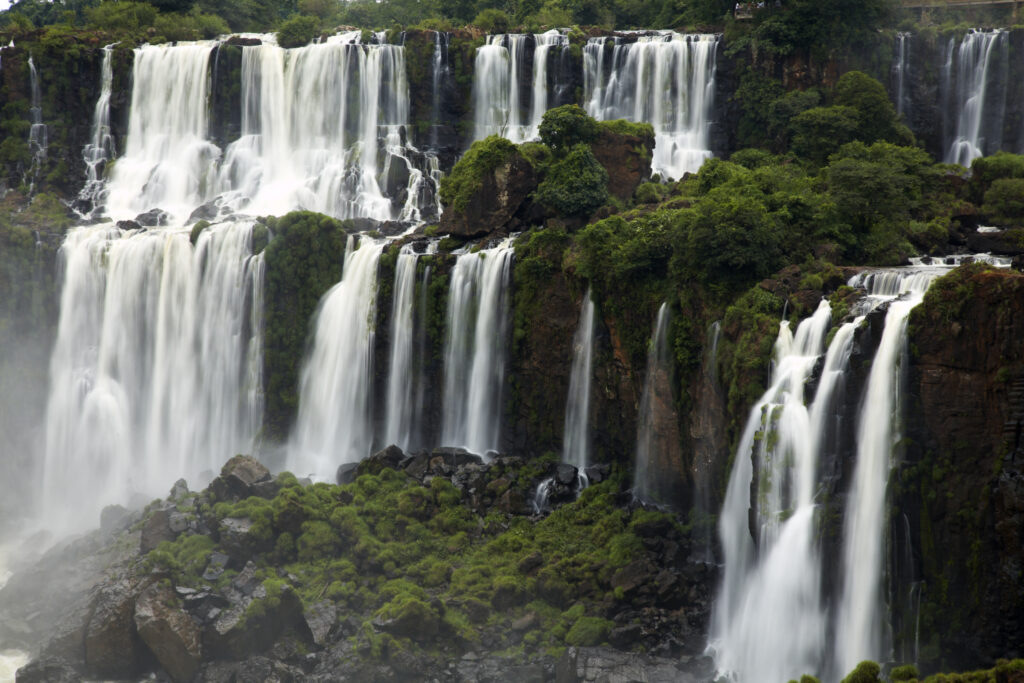 Argentina, Misiones, Iguazu National Park. Tourists admire the impressive Iguazu waterfalls - A world heritage site.