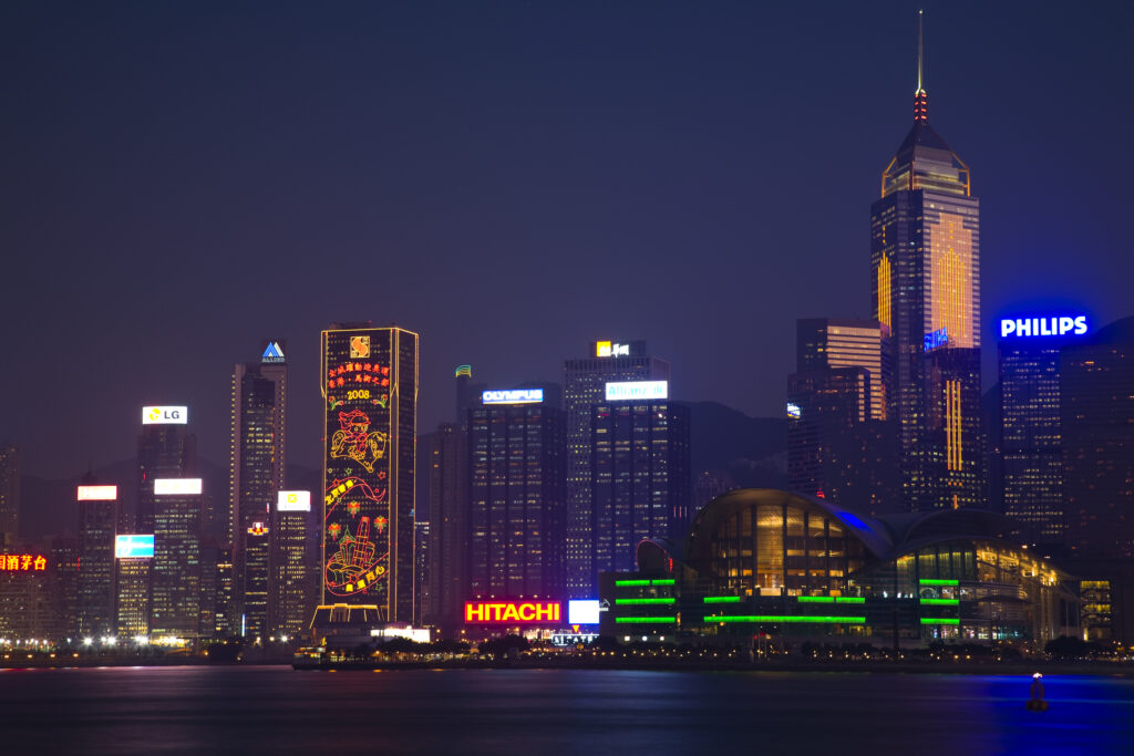 People's Republic of China, Hong Kong Special Administrative Region, Kowloon. The skyline of Kong Kong island viewed at dusk across Victoria Harbour from Kowloon.