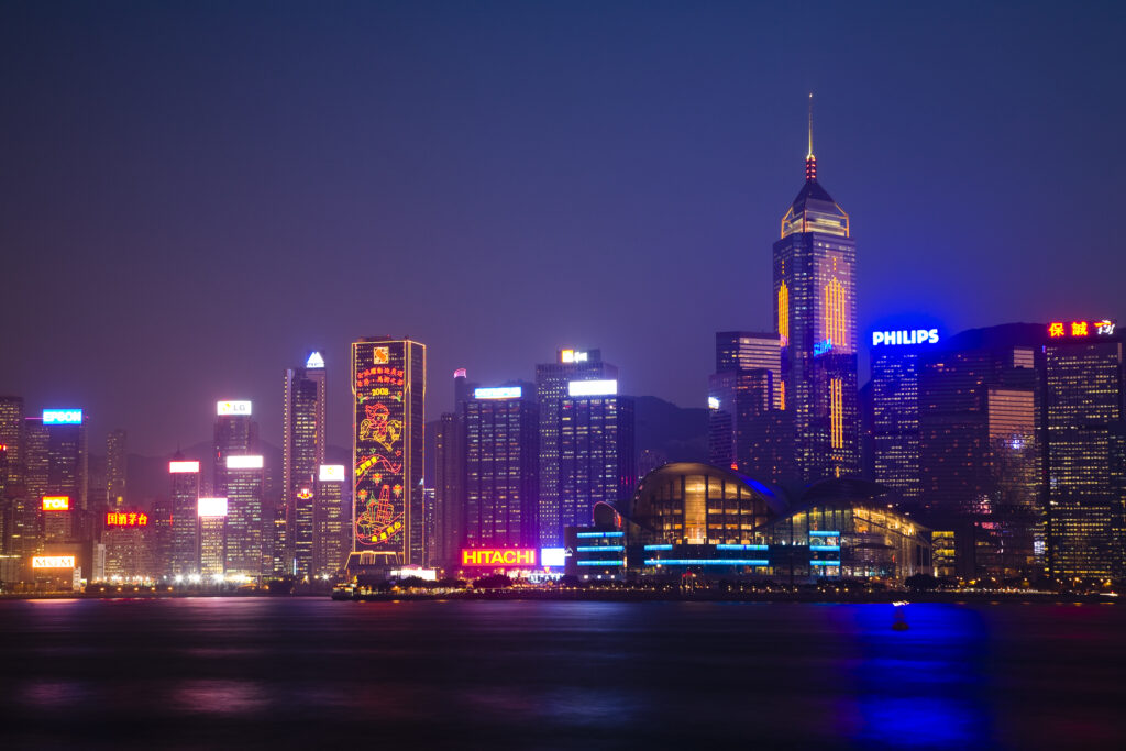 People's Republic of China, Hong Kong Special Administrative Region, Kowloon. The skyline of Kong Kong island viewed at dusk across Victoria Harbour from Kowloon.