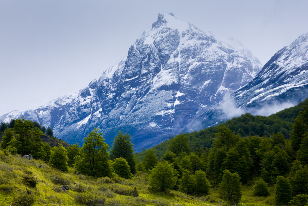 chile, Southern Patagonia, Torres Del Paine National Park. Storm clouds retreat to reveal the dramatic mountain peaks of the Torres Del Paine National Park viewed from the 'Circuit' track.