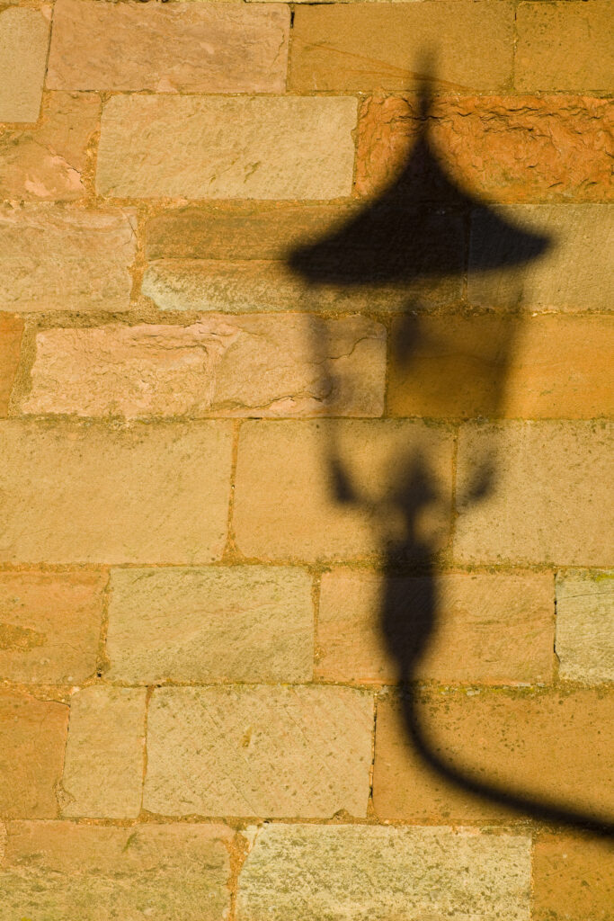 Scotland, Scottish Borders, Coldingham. Shadow of a lamp on the walls of Coldingham Priory.