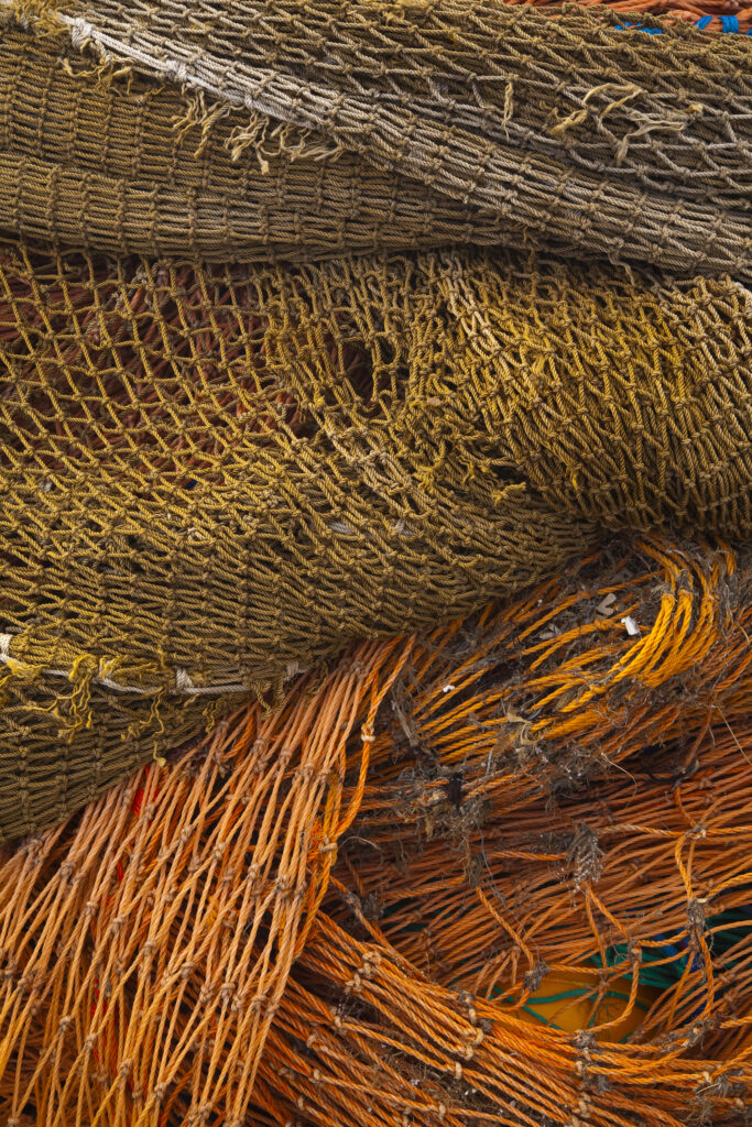 Scotland, Scottish Borders, Eyemouth. Entwined fishing nets stored in the harbour of Eyemouth.