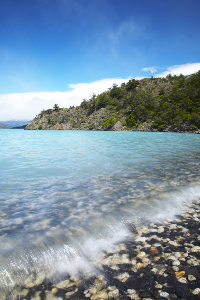 Chile, Southern Patagonia, Torres Del Paine National Park. Waves crashing against a bay of pebbles at Lago Nordenskjold.