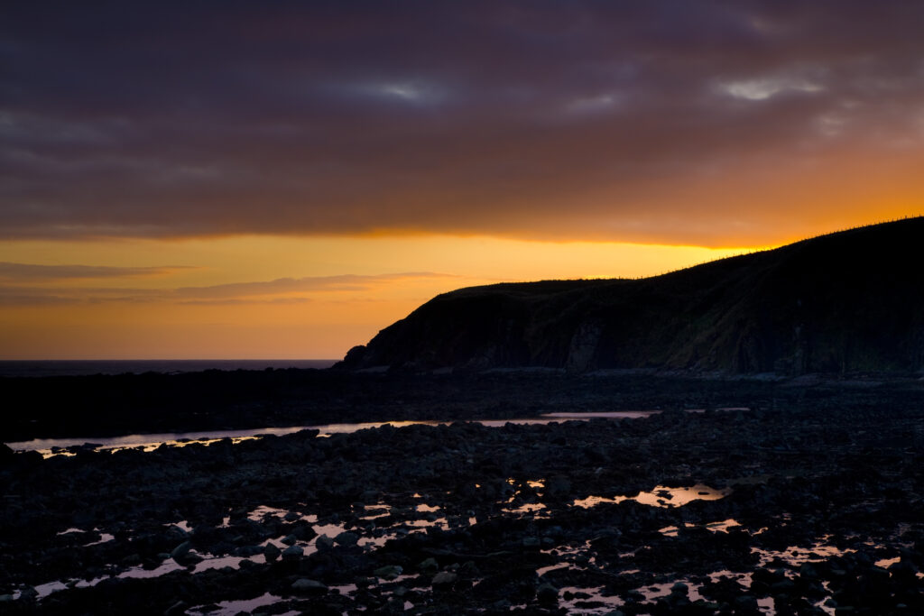 Scotland, Scottish Borders, Burnmouth. Sunrise over the North Sea near the village of Burnmouth – the first settlement to be found in Scotland after crossing the English border near the coast.