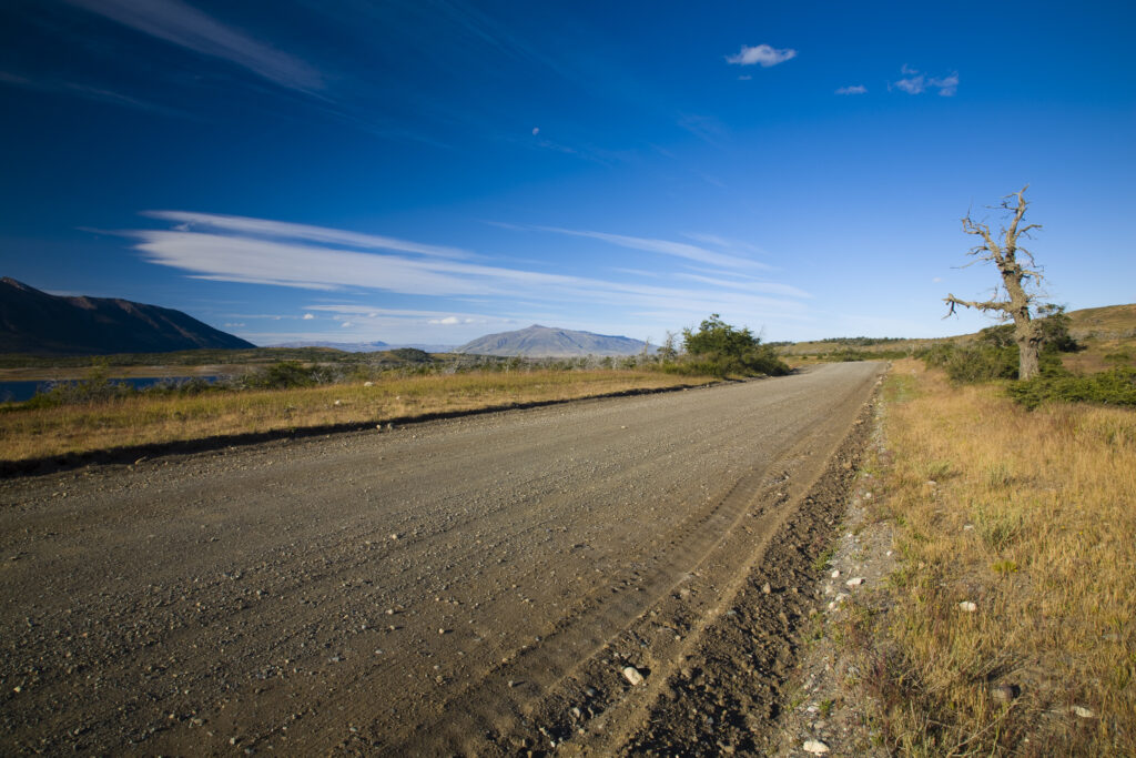 Argentina, Patagonia, Los Glaciares National Park. A rural road through a typical Patagonia Steppe lanscape.