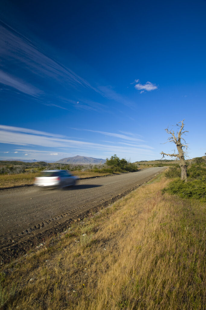Argentina, Patagonia, Los Glaciares National Park. A rural road through a typical Patagonia Steppe lanscape.