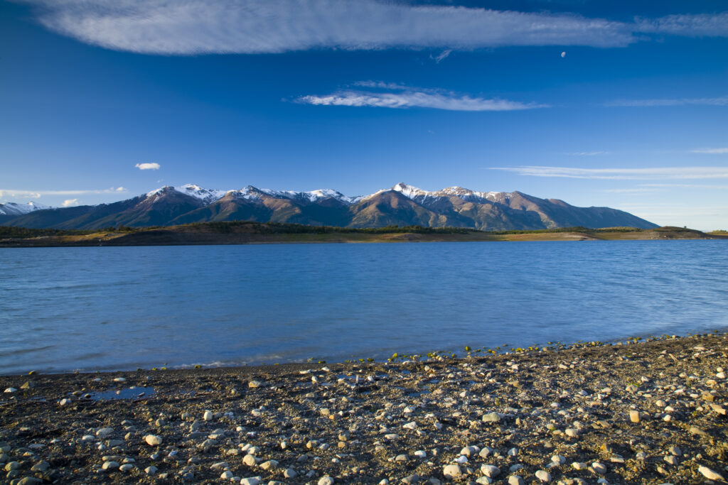 Argentina, Patagonia, Los Glaciares National Park. The shoreline of Lake Roca, against a mountain backdrop.