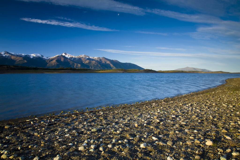 Argentina, Patagonia, Los Glaciares National Park. The shoreline of Lake Roca, against a mountain backdrop.