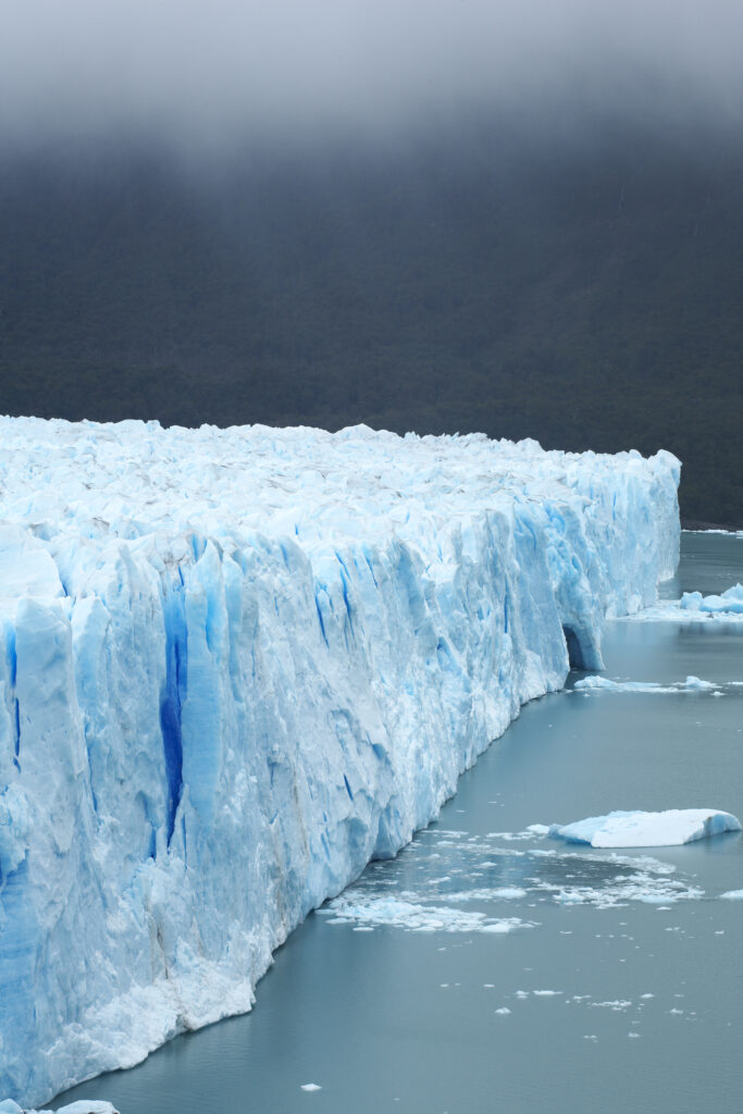 Argentina, Patagonia, Los Glaciares National Park. Rain clouds hang over the Perito Moreno Glacier.