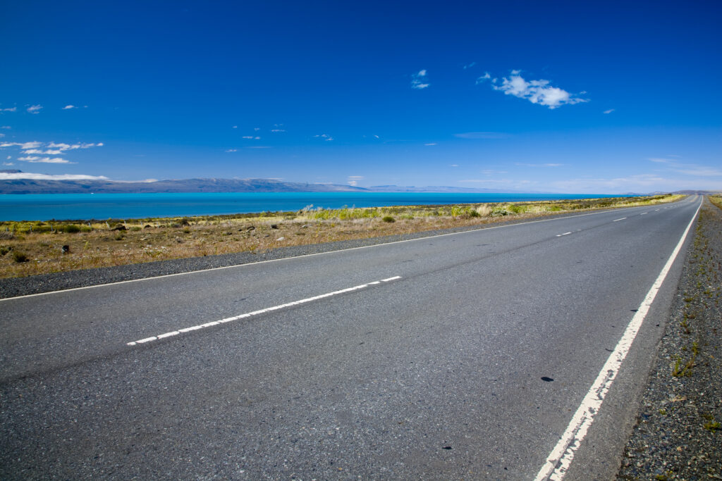 Argentina, Patagonia, Santa Cruz. Highway road running alongside Lake Argentina through the open patagonian landscape.