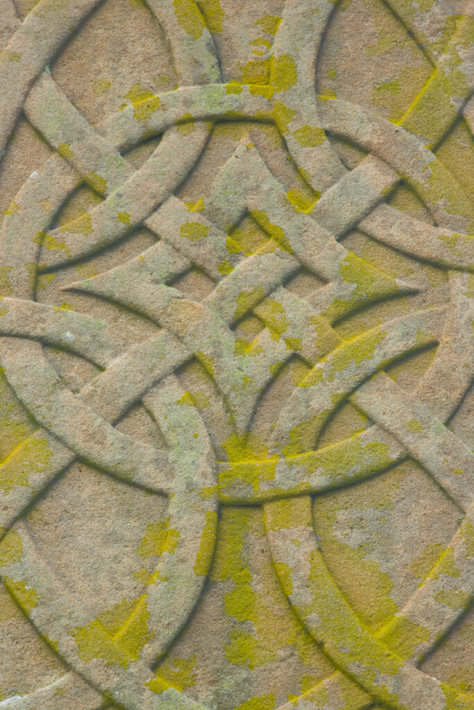 Scotland, Scottish Borders, Ladykirk. Celtic design on a war memorial cross within the grounds of the church of Ladykirk.