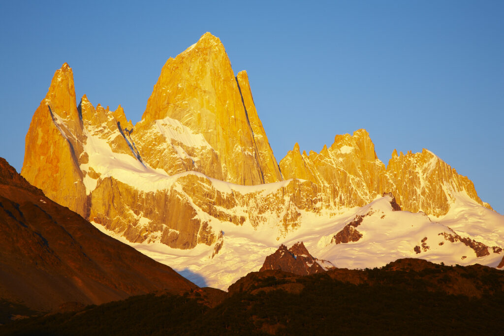 Argentina, Patagonia, Los Glaciares National Park. Dawn light hits the peaks of the Poincenot, Fitz Roy, Mermoz and Guillaumet mountains.