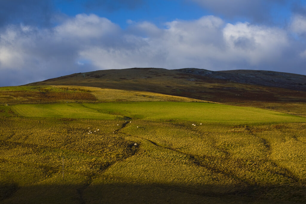 Scotland, Scottish Borders. Sun breaking though a storm highlights the features of the uplands to be found near Blake Muir.