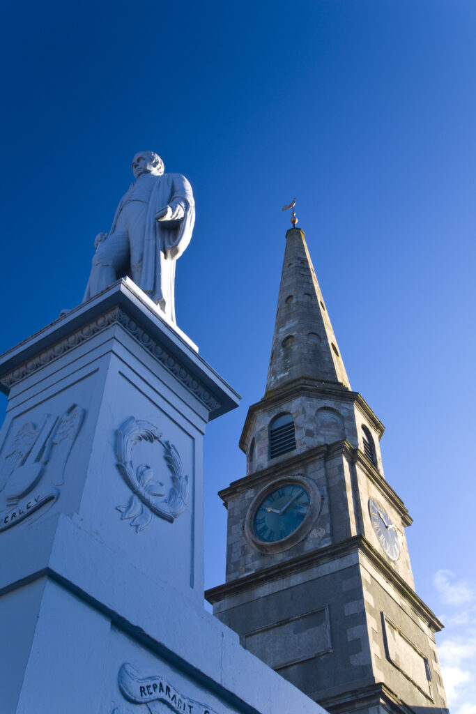 Scotland, Scottish Borders, Selkirk. Sir Walter Scott monument and Town Hall clock situated in the market place of Selkirk.