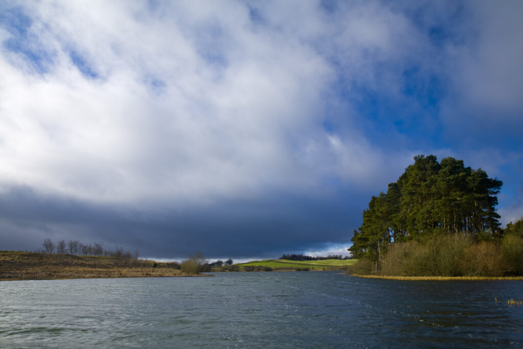 Scotland, Scottish Borders, Lindean Loch. Dramatic skies over Lindean Loch, Whitlaw Mosses National Nature Reserve.