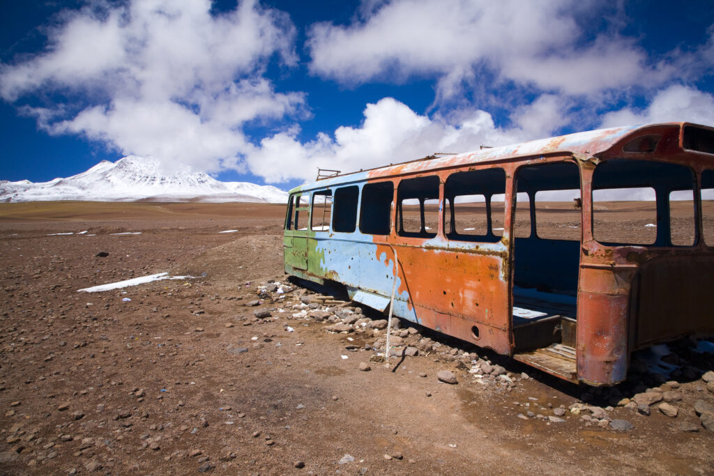 Bolivia, Southern Altiplano, Portezuelo del Cajon. Abandonded bus shell rustin near the Chilean Border.