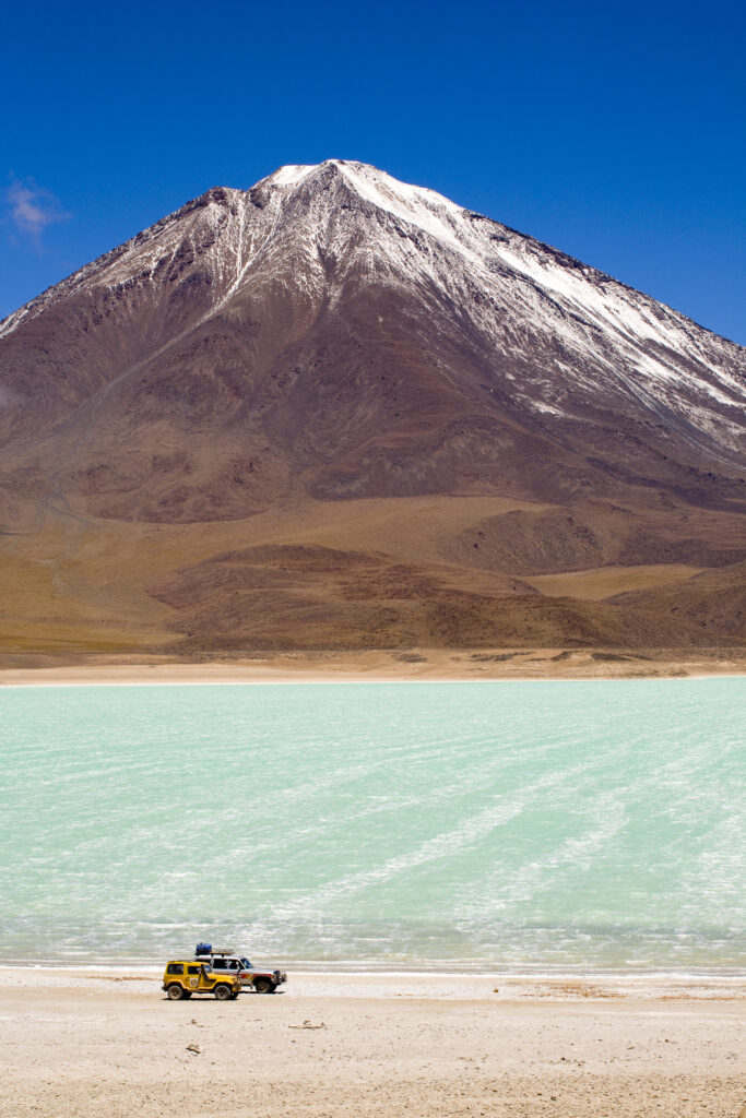 Bolivia, Southern Altiplano, Laguna Verde. Tourist trip 4x4s parked near Laguna Verde and Volcan Licancabur.
