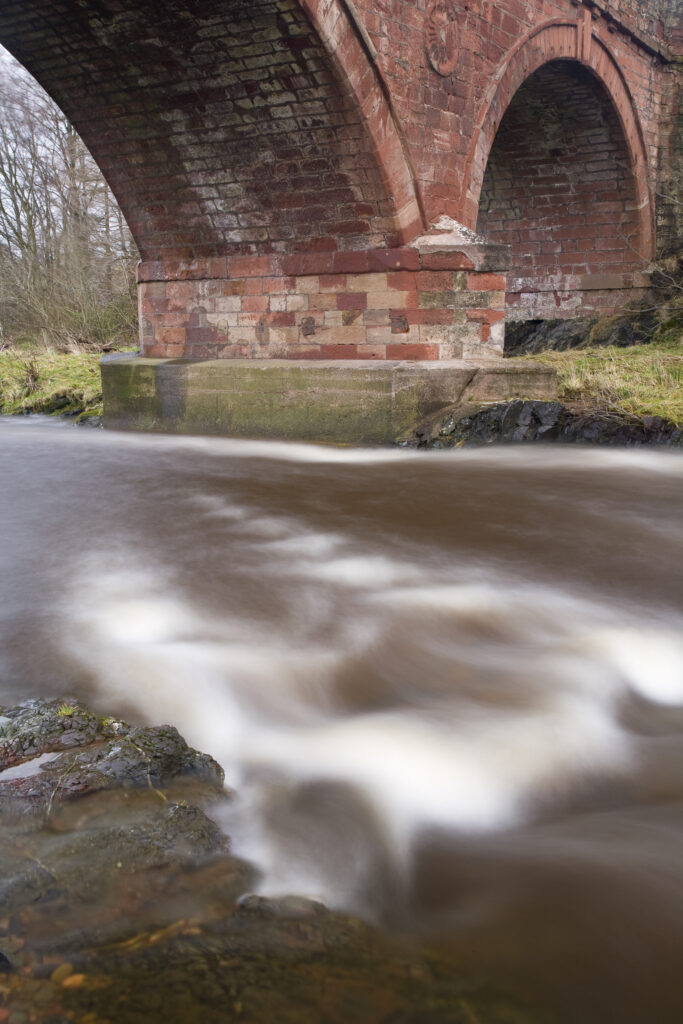 Scotland, Scottish Borders, Whiteadder Water. A typical example of a stone arched bridge to be found in the borders region, spanning across Whiteadder water near Duns.