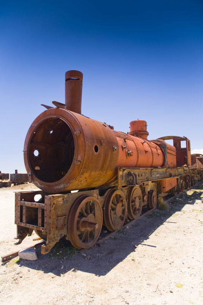 Bolivia, Southern Altiplano, Uyuni. Rusty Locomotive within a train cementary near Uyuni.