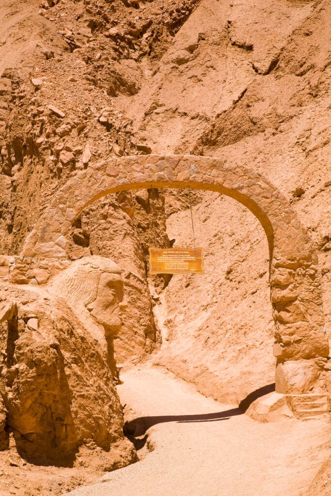 Chile, Atacama Desert, Plaza Quitor. Carved face in the stone wall of the Atacama Desert near the Plaza Quitor.
