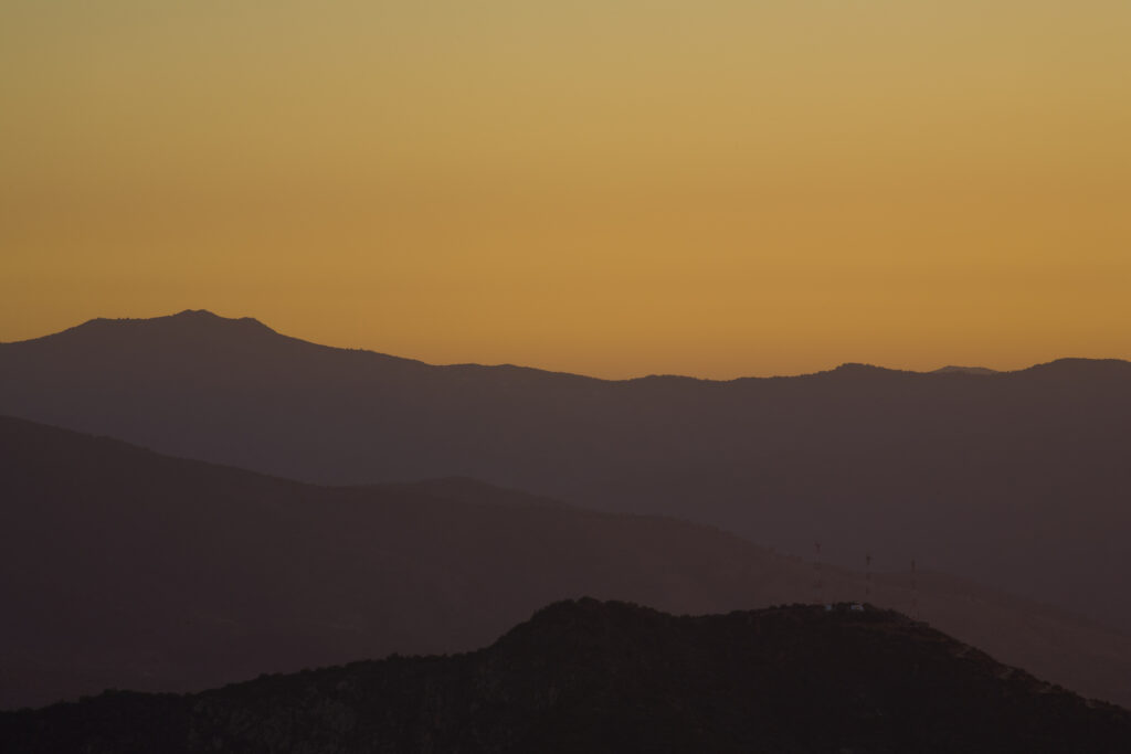 Chile, Valparaíso V, Parque Nacional La Campanan. Sunset behind the mountains of the National Park.