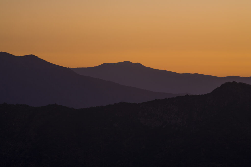 Chile, Valparaíso V, Parque Nacional La Campanan. Sunset behind the mountains of the National Park.
