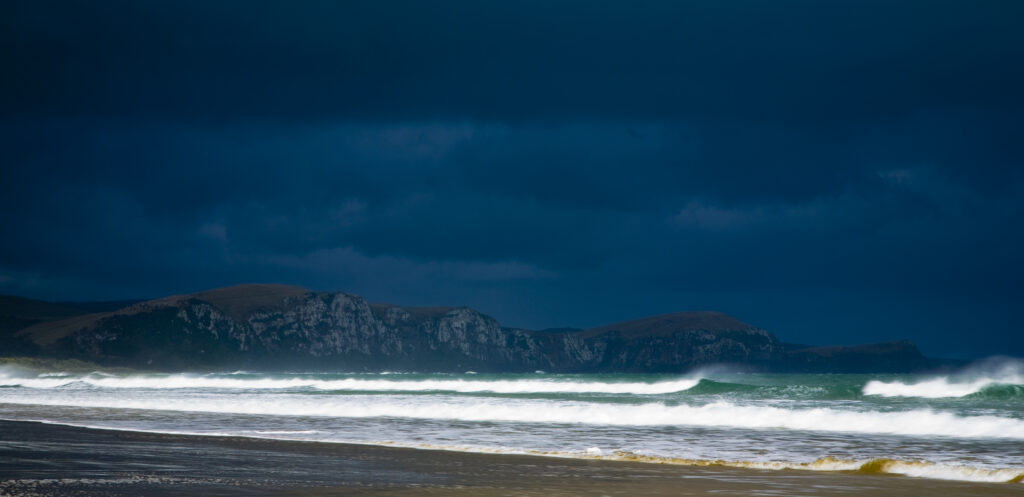 New Zealand, Southland, The Catlins. A storm brews over Tahakopa Bay near the town of Papatowai.