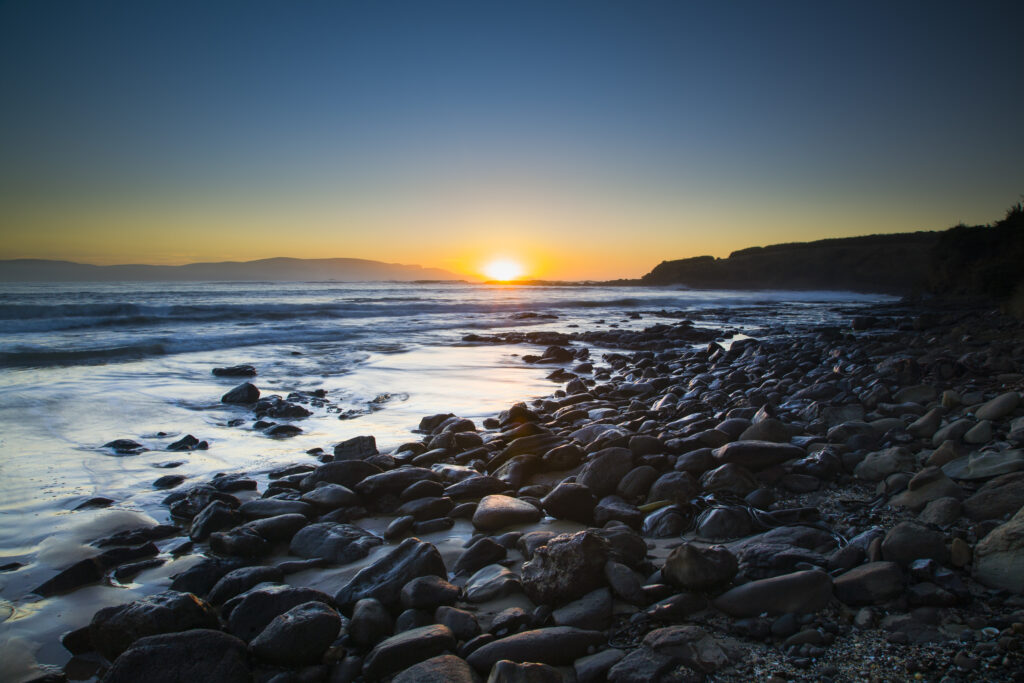 New Zealand, Southland, The Catlins. Dawn looking towards the Brothers Point, viewed from Porpoise Bay.