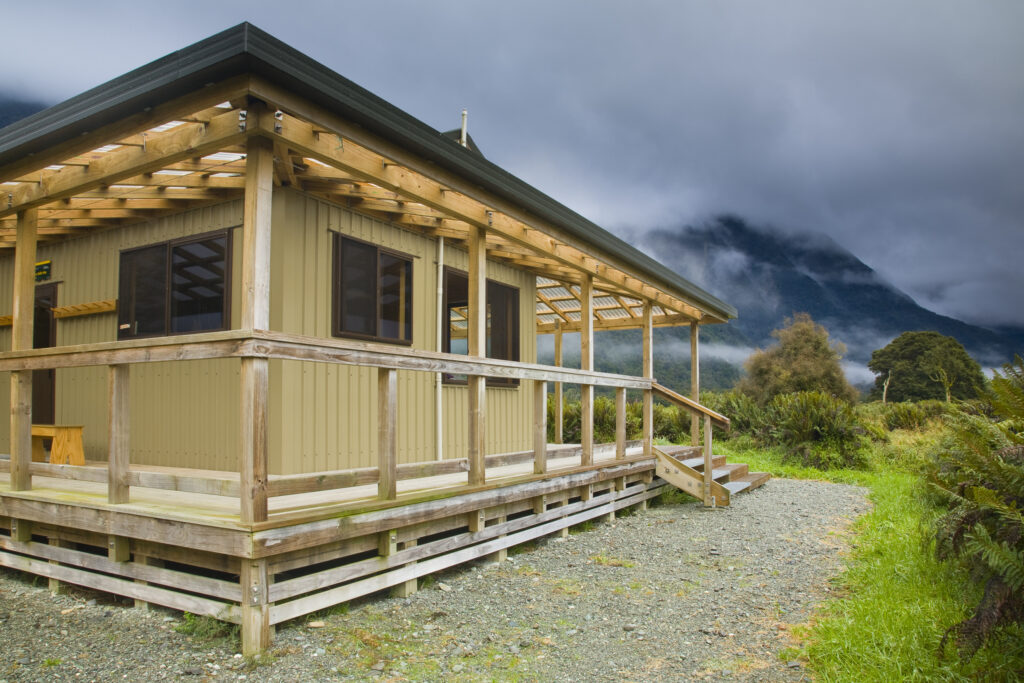 New Zealand, Southland, Fiordland National Park. Hidden Falls Hut, one of the many huts offering day and overnight shelter along the Hollyford Track.