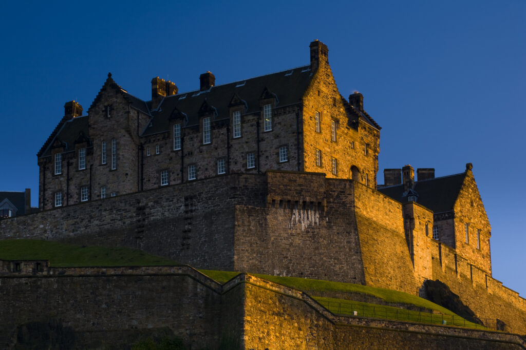 Scotland, Edinburgh, Edinburgh Castle. The last light of the setting sun illuminates Edinburgh Castle.
