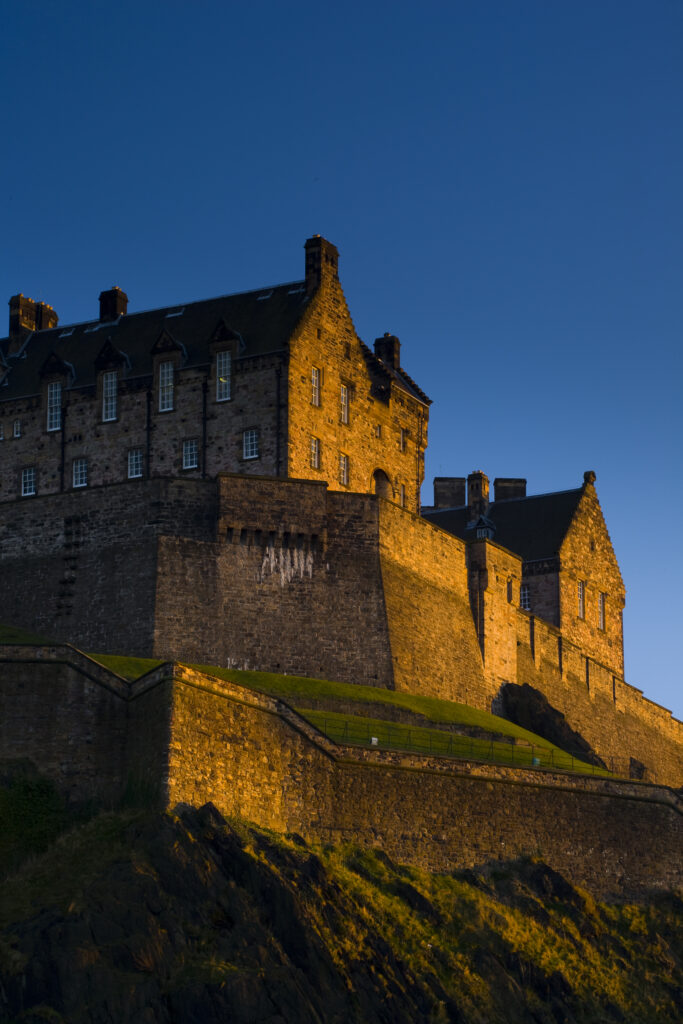 Scotland, Edinburgh, Edinburgh Castle. The last light of the setting sun illuminates Edinburgh Castle.