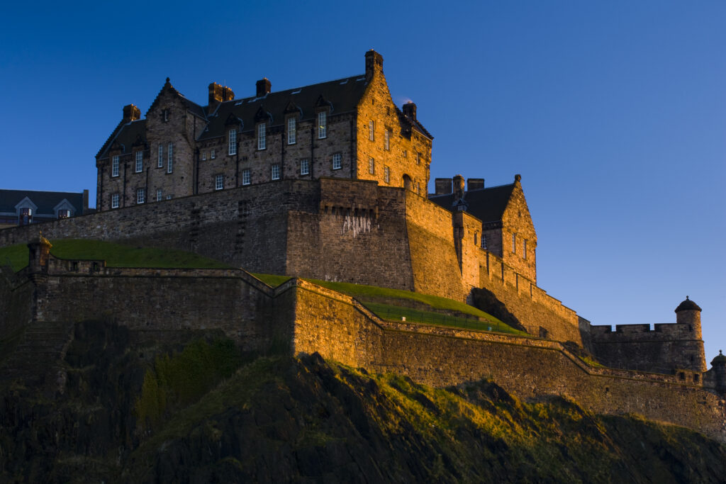 Scotland, Edinburgh, Edinburgh Castle. The last light of the setting sun illuminates Edinburgh Castle.
