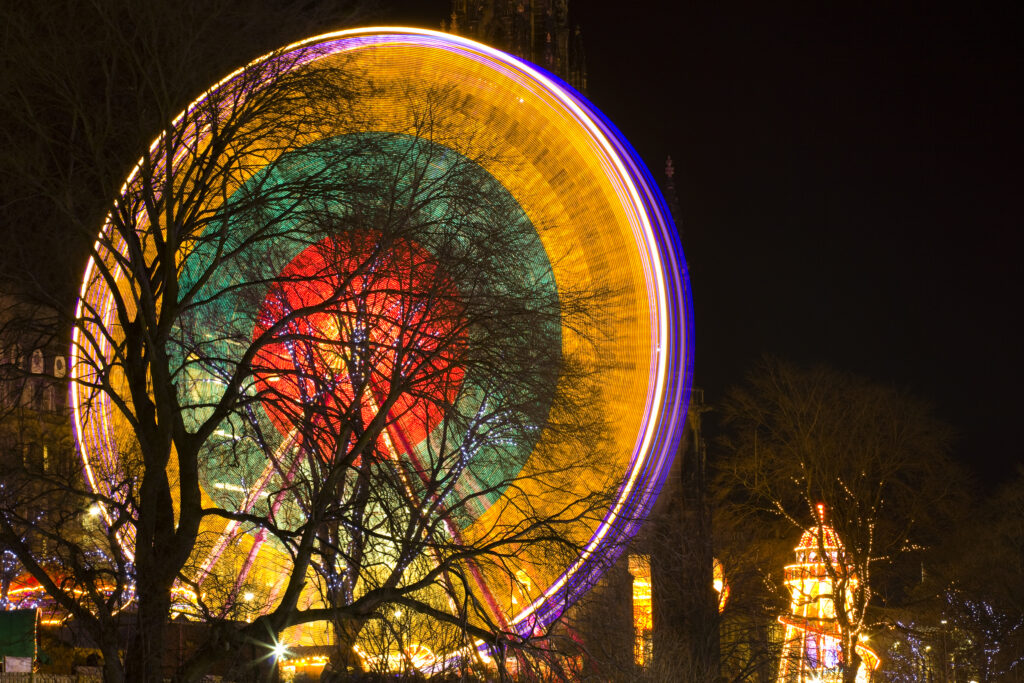 Scotland, Edinburgh, Christmas Fair. Ferris wheel located near the Scott Monument in East Princes Street Gardens.