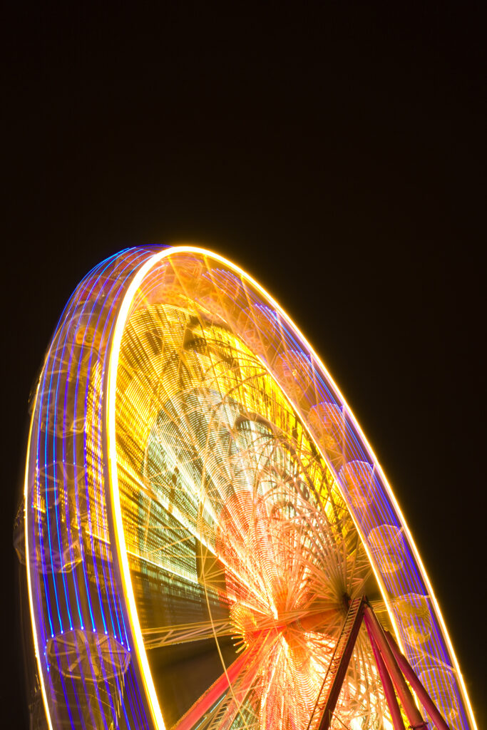 Scotland, Edinburgh, Christmas Fair. Ferris wheel located near the Scott Monument in East Princes Street Gardens.